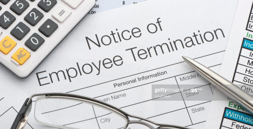Close up of Employee termination form with pen and calculator
